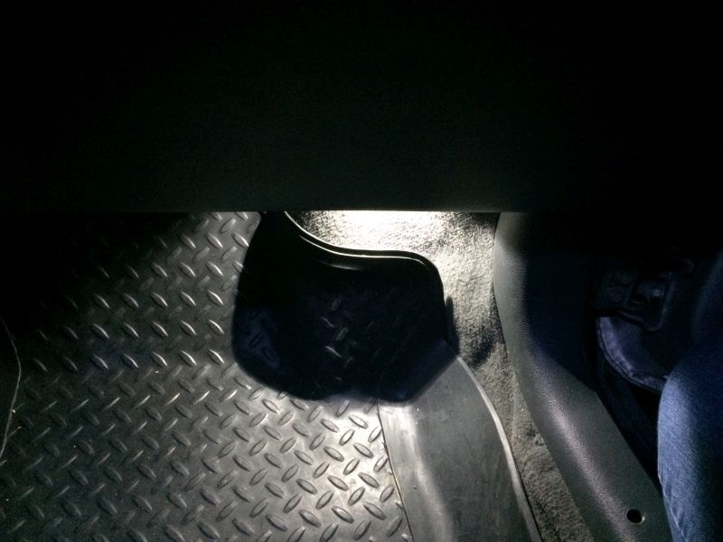 Diamond plate floor mat and black trim in a vehicle interior.