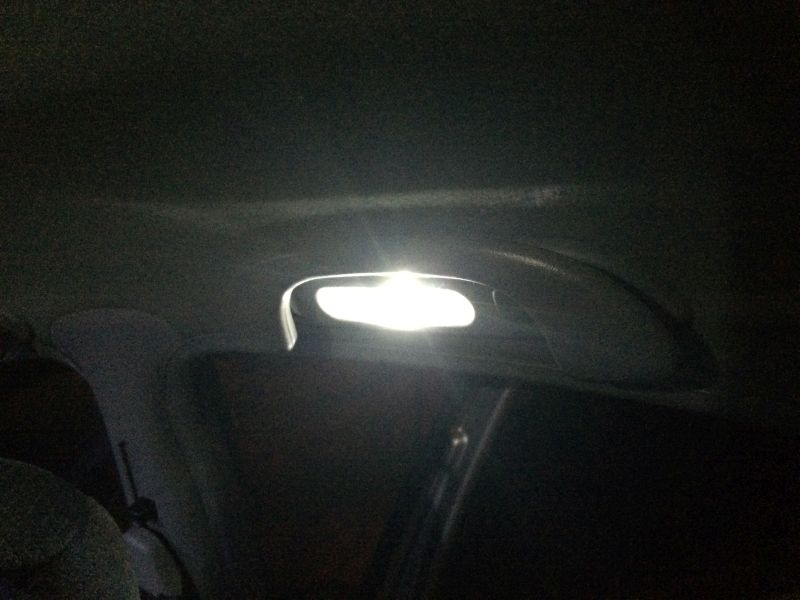 Interior overhead light illuminated in a car.