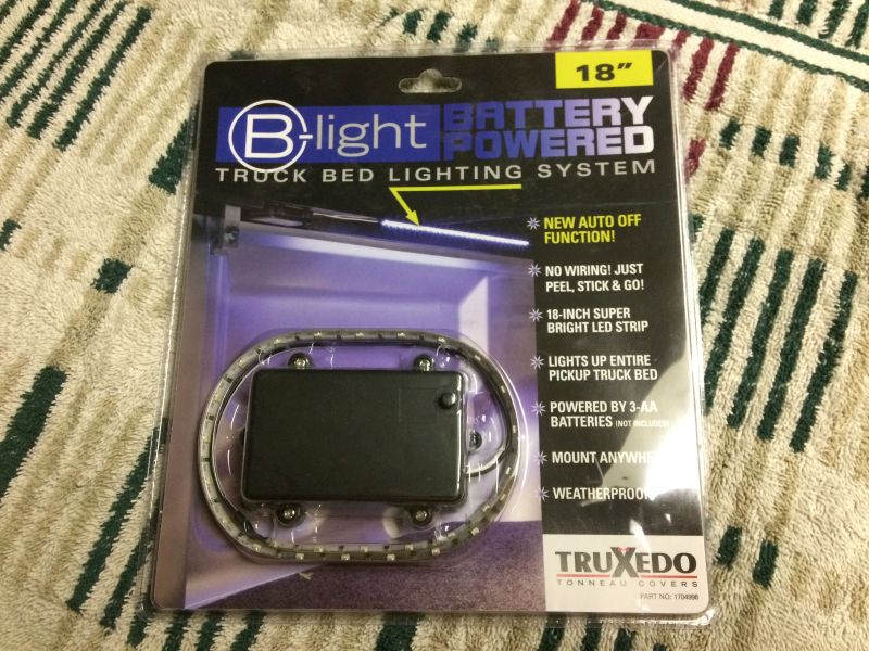 Truxedo B-Light #1704998; runs on 3 AA batteries and powers off after 5 minutes.