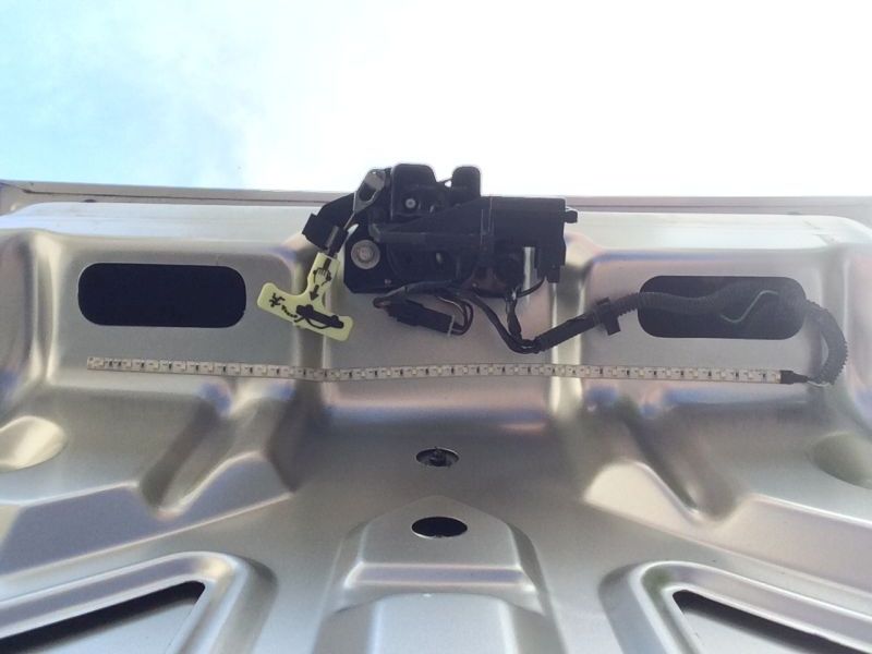 Underside of car hood with latch and LED strip lights