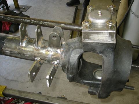 1994 Ford Bronco - Close-up of a custom-fabricated axle housing, showing welded brackets for suspension components.