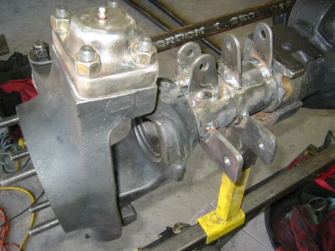 1994 Ford Bronco - Close-up of a custom axle assembly welded brackets and a greased fitting.