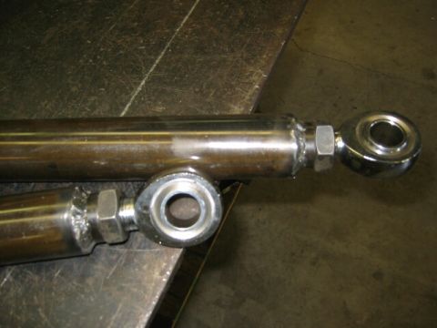 1994 Ford Bronco - Two metal rod ends are shown, likely for a vehicle's suspension or steering system.