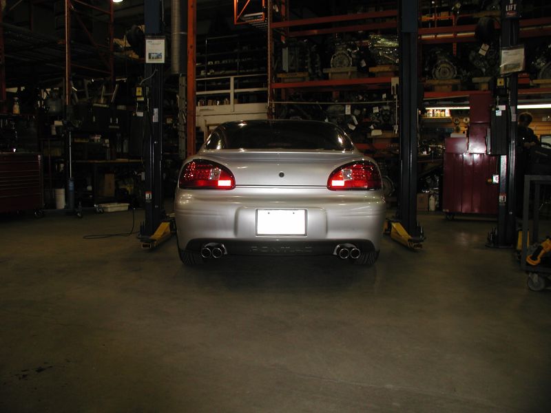 Silver 2002 Pontiac Grand Prix rear view in a garage.