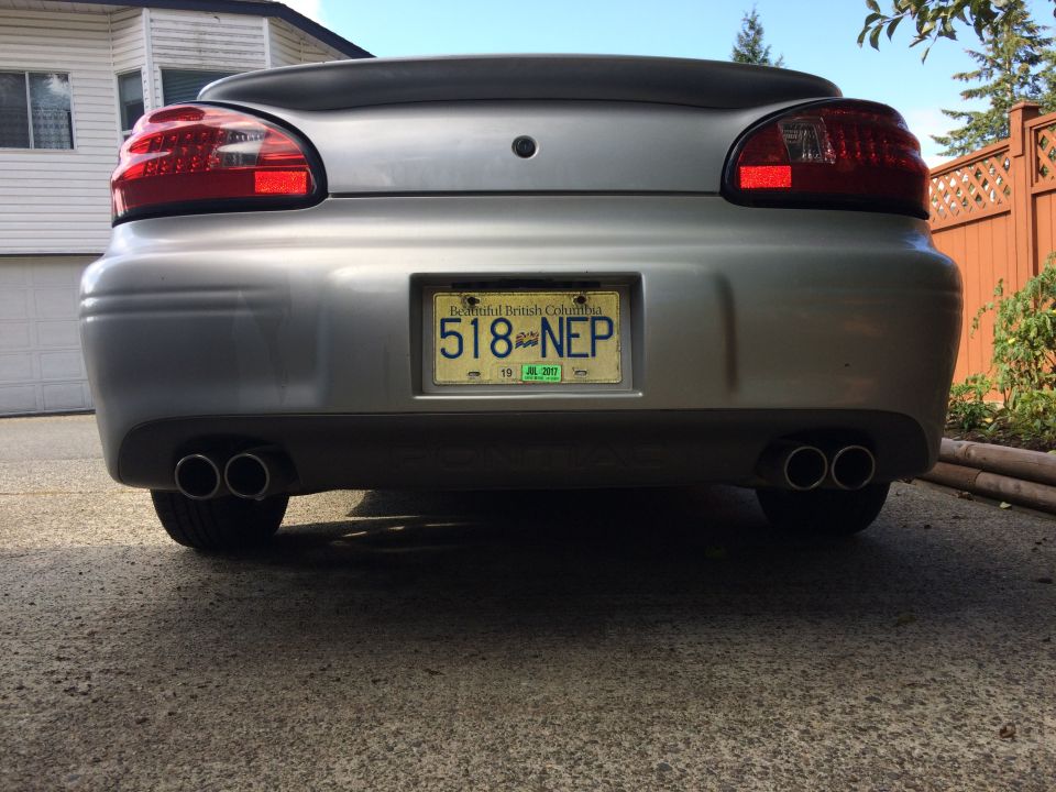 Rear view of a silver Pontiac Grand Prix with dual exhaust and BC license plate 518-NEP.
