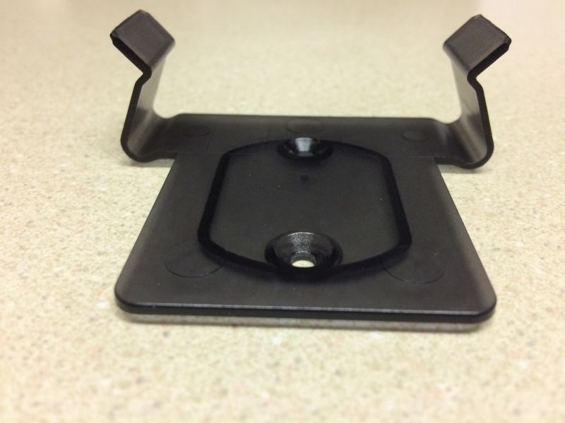 Black plastic mounting bracket with prongs