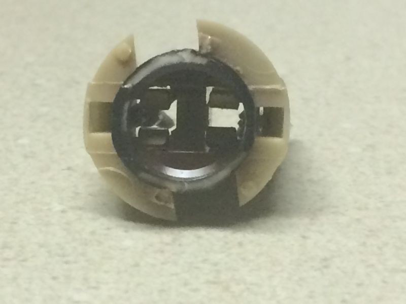Beige plastic and black electrical component with metal contacts