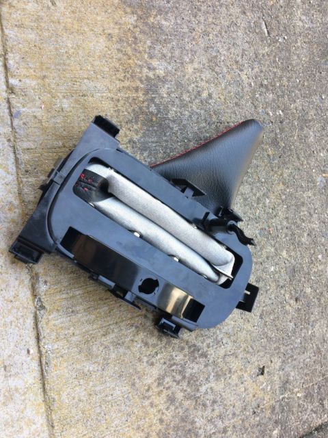 2002 Pontiac Grand Prix - A detached car part, likely an airbag module, is shown lying on a concrete surface. The part features black plastic housing and a folded, l…