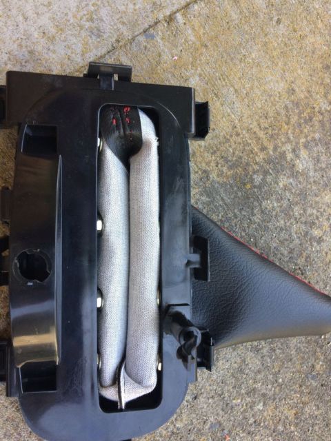 2002 Pontiac Grand Prix - A deployed airbag module is shown, partially encased in black plastic housing. The airbag itself is made of light gray fabric, folded and s…