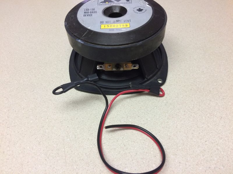 Speaker with red and black wires, labeled LXD-130 MID-BASS DEVICE.