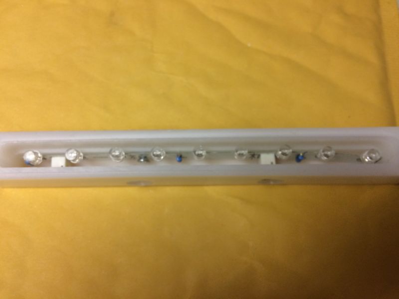 LED light bar in a translucent casing on a yellow surface
