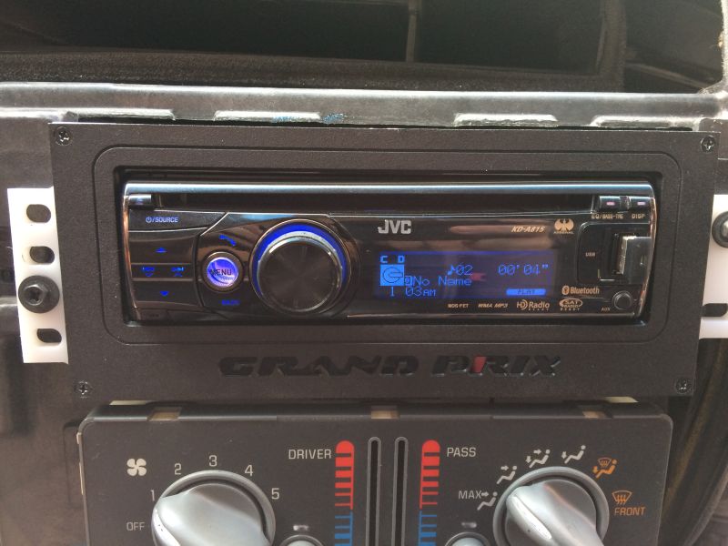 JVC KD-A815 car stereo and climate controls in a vehicle dashboard.