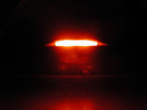 2002 Pontiac Grand Prix - A bright red taillight is illuminated against a dark background. The light is horizontal and spans across the center of the frame.