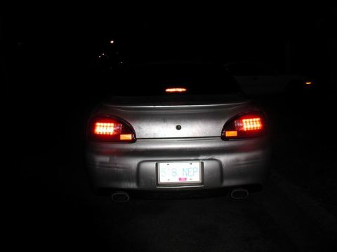 2002 Pontiac Grand Prix - The rear of a silver Pontiac Grand Prix is shown at night with its brake lights illuminated. The license plate reads "518 NEP".