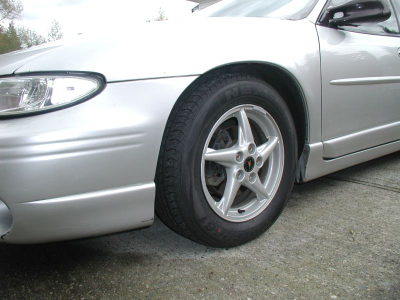 Silver 2002 Pontiac Grand Prix passenger front wheel and fender