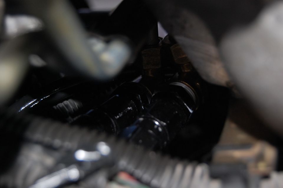 Close-up of black hydraulic fittings with brass accents.