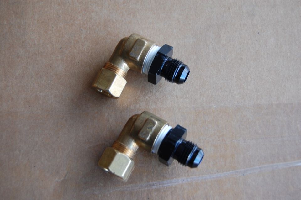 Two brass 90-degree AN fittings with black adapters.