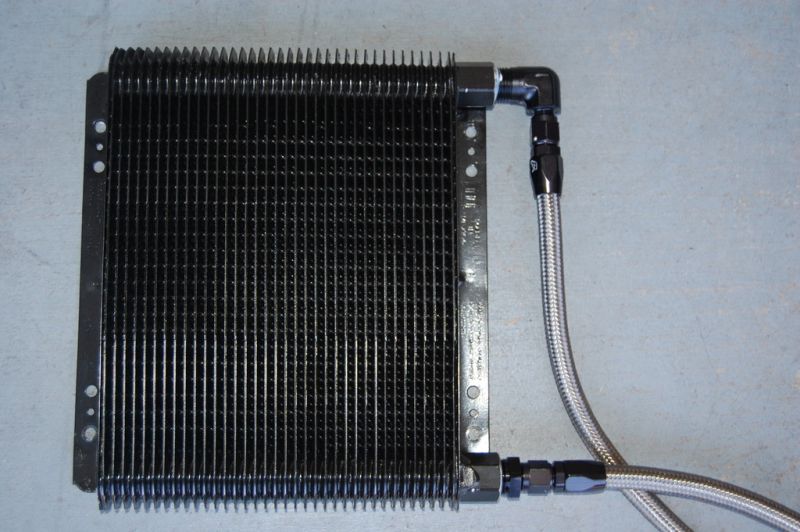 Black oil cooler with braided stainless steel lines and black AN fittings.