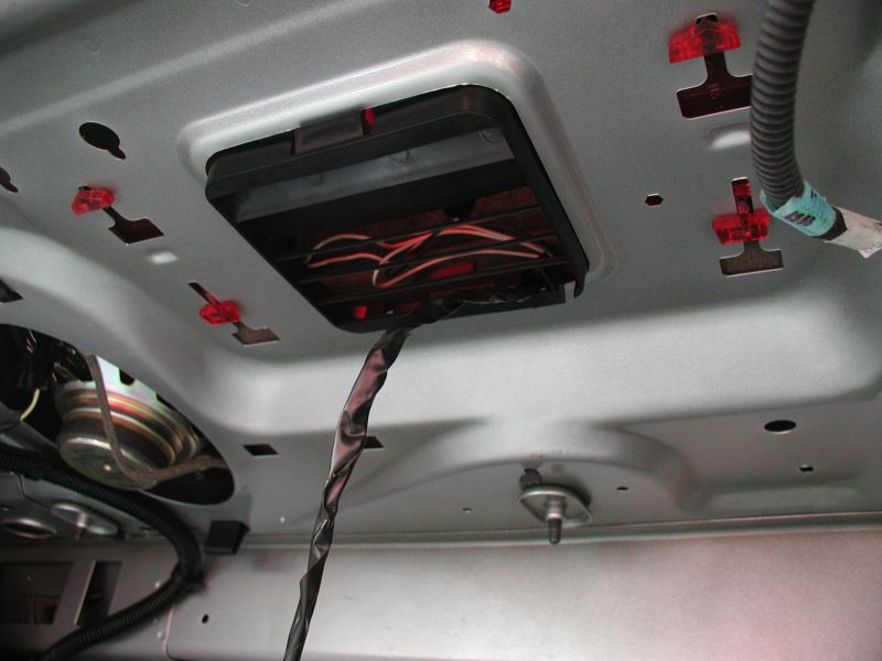 Unplug the light, feed the harness through the opening at the front of the plastic cover and clip the cover back into place.
