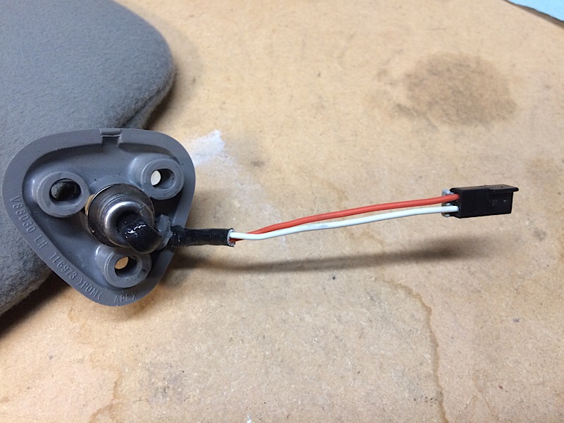 Gray sun visor with light socket and red/white wire connector