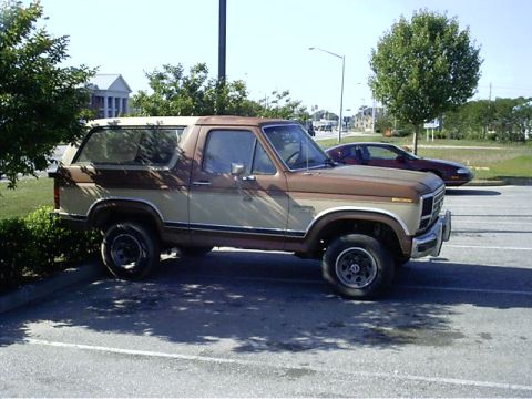 1985 Ford Bronco - This two-tone 1985 Ford Bronco is seen from the side in a parking lot.
