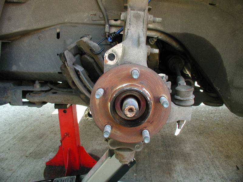 Remove the caliper (2 x 15mm), then the hub (3x 13mm).