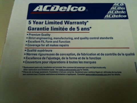 2002 Pontiac Grand Prix - A close-up shot of an ACDelco 5 Year Limited Warranty document. The document is white with blue and red text and lists warranty details in…