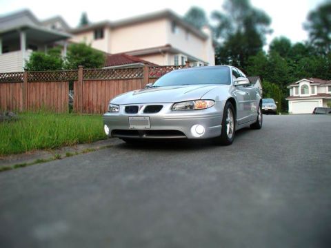 Silver 2002 Pontiac Grand Prix parked on street, low angle front 3/4 view.