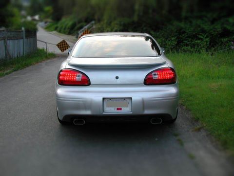 Silver 2002 Pontiac Grand Prix rear view with aftermarket taillights and dual exhaust