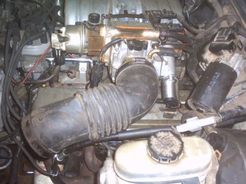 1991 Ford LTD Crown Victoria - Close-up view of a vehicle's engine bay, showing intricate mechanical components and wiring.
