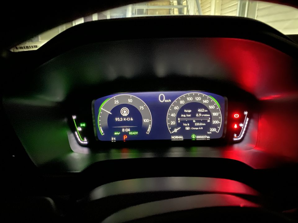 Digital dashboard of a modern car showing speed, fuel, trip info, time, and readiness status.