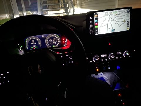 2026 Honda CR-V - The interior of a modern car at night, featuring a digital dashboard with navigation displayed on the infotainment screen and illuminated c…