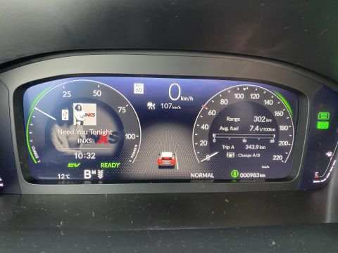 2026 Honda CR-V - The digital dashboard of a car displays the current speed, range, average fuel consumption, and song information. The screen shows the song…