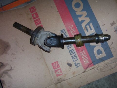 2000 Ford F-450 - A driveshaft component is shown resting on a cardboard box with visible text.