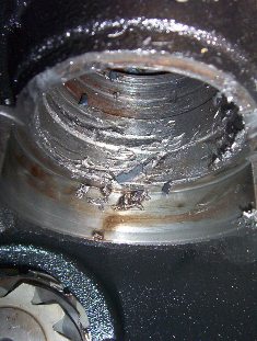 2000 Ford F-450 - This engine bearing shows significant damage and wear, indicating a potential mechanical failure.