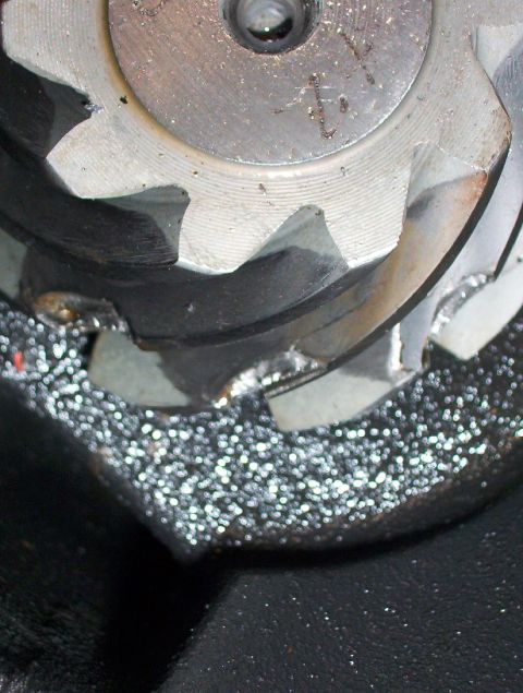 2000 Ford F-450 - A close-up view reveals damaged gear teeth on a mechanical part, suggesting a failure within a larger system.