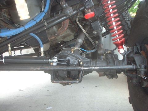 1995 Ford Bronco - Undercarriage view shows the front axle and suspension system with various mechanical parts.
