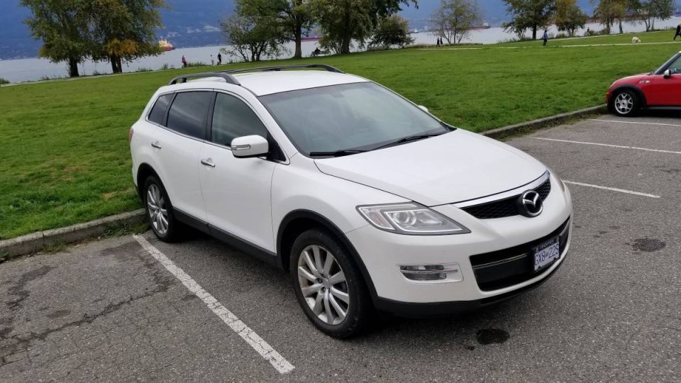 White 2009 Mazda CX-9 parked in a lot, front passenger side view.