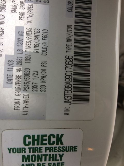 2009 Mazda CX-9 - This is a close-up of a vehicle's tire information sticker, showing details like tire size, pressure, and VIN. Below the sticker is a green…