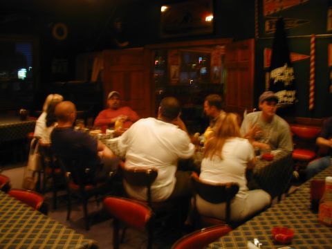 1988 Ford Bronco - A group of people are seated at tables inside a restaurant, with some engaged in conversation.