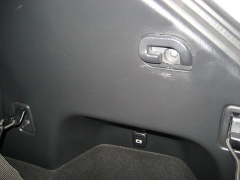 2009 Mazda CX-9 - This is a close-up interior shot of the cargo area of a 2009 Mazda CX-9. Visible are tie-down hooks, a USB port, and the textured plastic t…