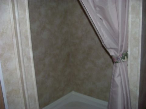 1992 Ford Bronco - A close-up view of an interior corner, a pink curtain and textured walls, with a website logo at the bottom.