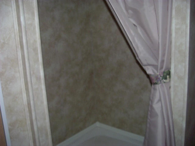 Interior corner of a room with a pink curtain and textured walls. Supermotors.net logo visible