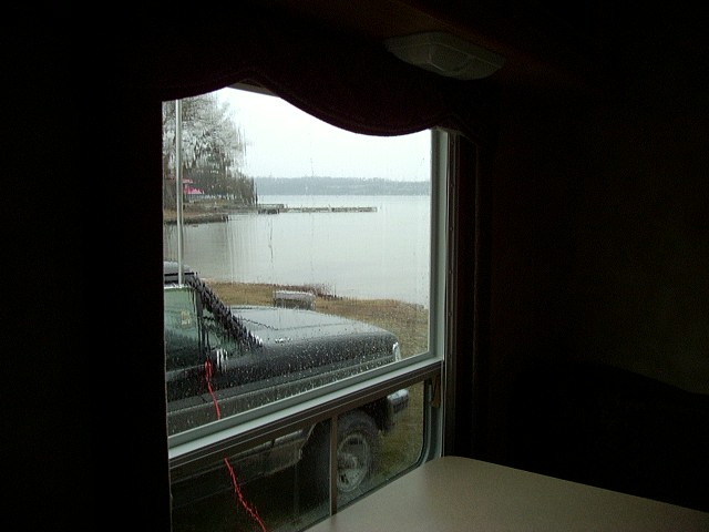 Black 1992 Ford Bronco parked by a lake, seen from inside a vehicle