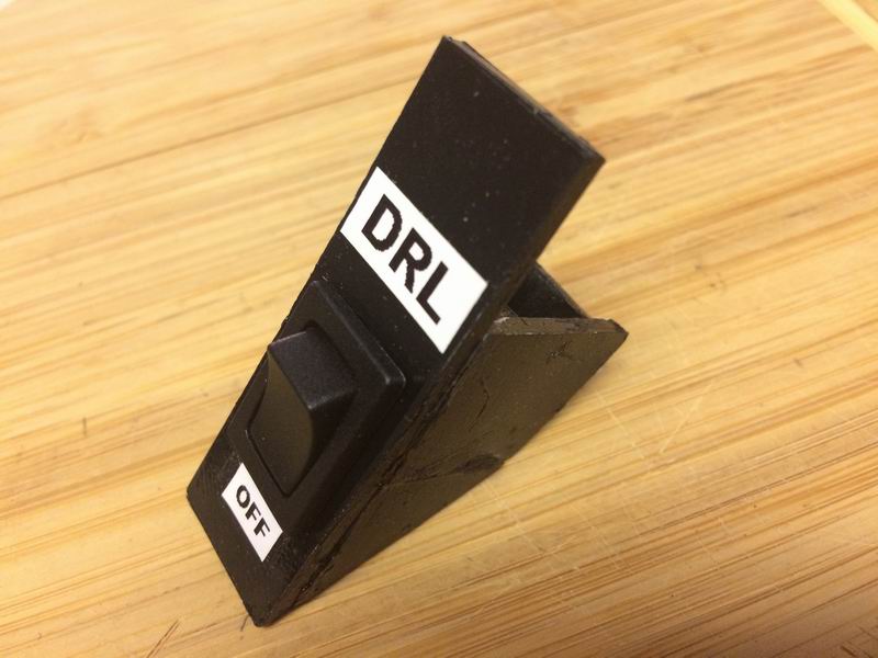 I made this plastic switch holder for the cubby, but the adhesive wouldn't hold and it ended up falling to pieces as I installed it.....