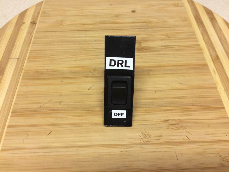 I made this plastic switch holder for the cubby, but the adhesive wouldn't hold and it ended up falling to pieces as I installed it.....