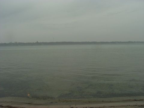 1992 Ford Bronco - A hazy view of a body of water with trees on the horizon, the Supermotors logo at the bottom right.