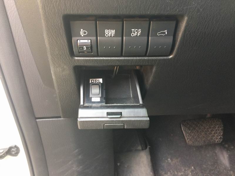 Close-up of dashboard buttons and a pedal in a 2009 Mazda CX-9.
