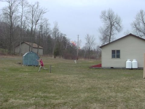 1992 Ford Bronco - A person plays in a grassy yard with a shed and a house in the background.