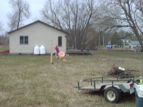 1992 Ford Bronco - Yard scene with child, house, propane tanks, and a trailer.
